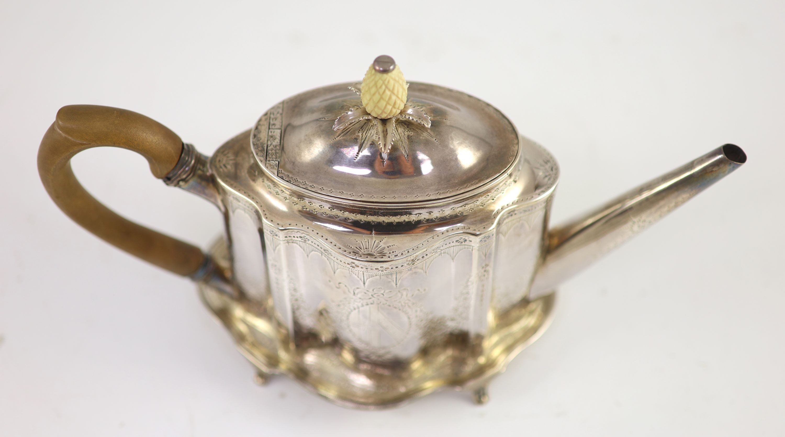 A George III silver bright cut engraved oval teapot and stand, Thomas Daniell